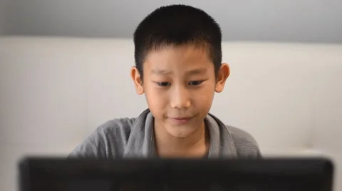 Boy playing game on computer Stock Footage 57348634