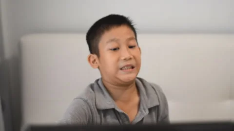 Boy playing game on computer Stock Footage 57360842