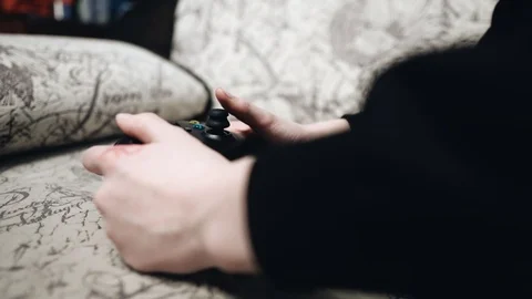 The boy is playing a game console. Close-up of hands. Children's entertainment. Stock Footage 124409239
