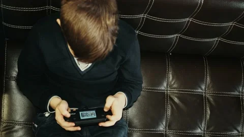 Boy playing a game on console Stock Footage 143758631