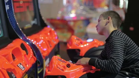 A boy playing a game on the game simulator Stock Footage 64973146