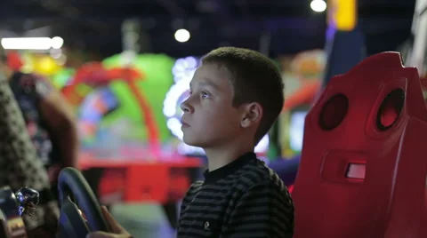 A boy playing a game on the game simulator Stock Footage 64978498