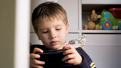 Boy playing game on mobile. Eye disease. Ophthalmology. Generation Z and new Video stock 127866418