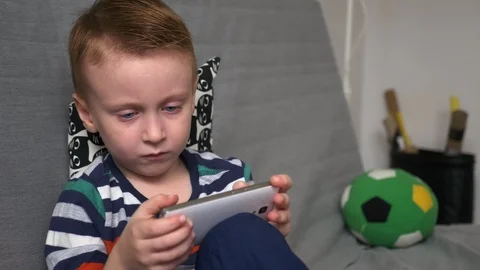 Boy playing game on mobile Stock Footage 98259018