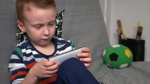 Boy playing game on mobile Stock Footage 98260077