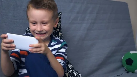 Boy playing game on mobile Stock Footage 98264000