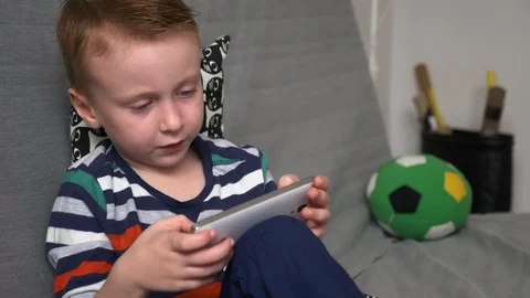 Boy playing game on mobile Stock Footage 98264507