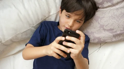 Boy playing game on phone Stock Footage 88908810