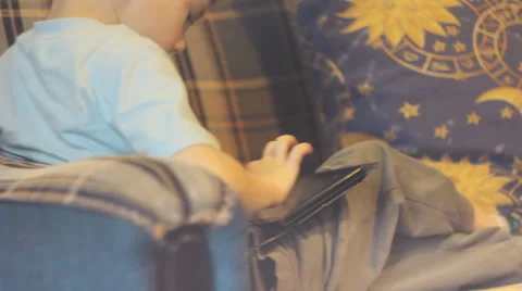 A boy playing a game on the tablet. Filmed with slider. Stock Footage 51879175