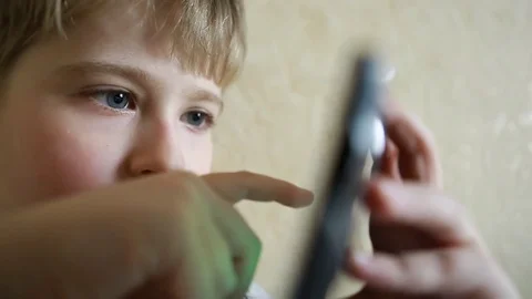  Boy playing a game on your smart phone Stock Footage 73008928