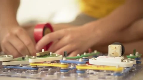 Boy playing games with the construction set. The child enthusiastically collects Stock Footage 166650054