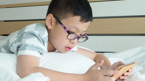 Boy playing games on digital tablet computer Stock Footage 89319801