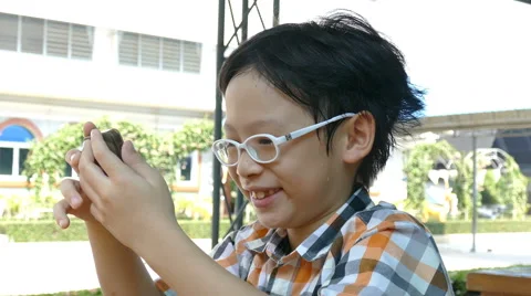 Boy playing games on phone Stock Footage 64412700