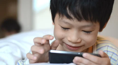 Boy playing games on smart phone Stock Footage 51515067