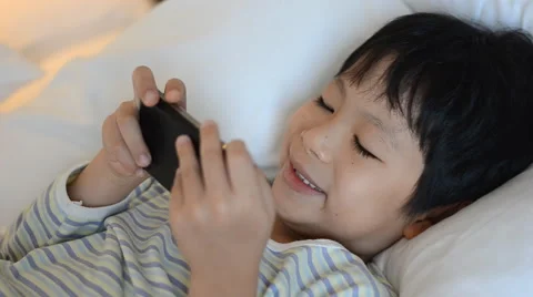 Boy playing games on smart phone Stock Footage 51518005