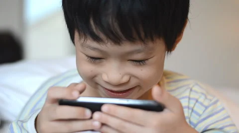 Boy playing games on smart phone Stock Footage 51532365