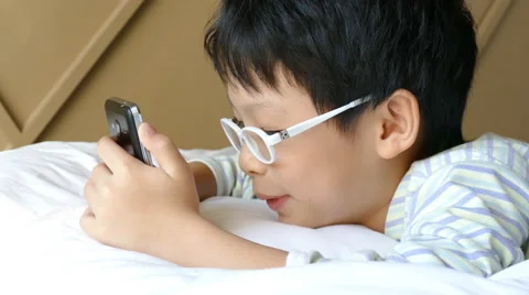 Boy playing games on smart phone Stock Footage 61689226