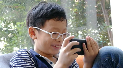 Boy playing games on smart phone Stock Footage 63654271