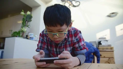 Boy playing games on smart phone Stock Footage 69894821