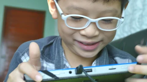 Boy playing games on the tablet computer Stock Footage 55195743
