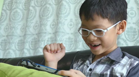 Boy playing games on the tablet computer Stock Footage 55196913