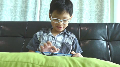 Boy playing games on the tablet computer Stock Footage 55199176