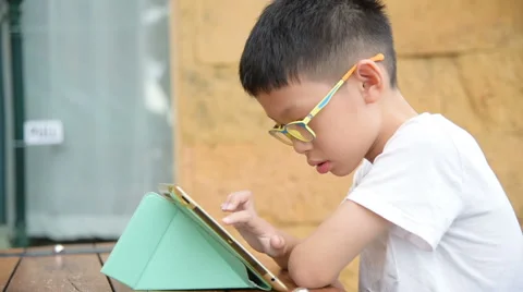 Boy playing games on tablet computer Stock Footage 67488992