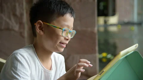 Boy playing games on tablet computer Stock Footage 67580371
