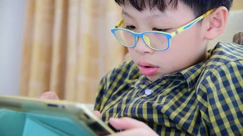 Boy playing games on tablet computer Stock Footage 74968179