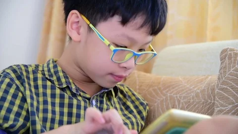 Boy playing games on tablet computer Stock Footage 74989996