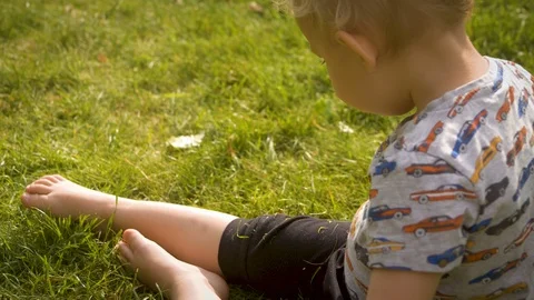 BOY playing on GRASS Stock Footage 89781422