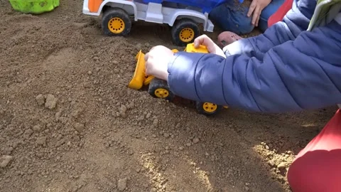 Boy Playing in Ground with Toy Dipper Video stock 148051050