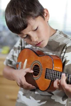 Boy playing guitar Stock Photos