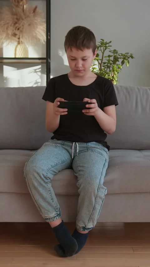Boy Playing Handheld Game Console Stock Footage 335483616