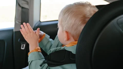 Boy Playing with Hands in Car Child Seat Stock Footage 307312155