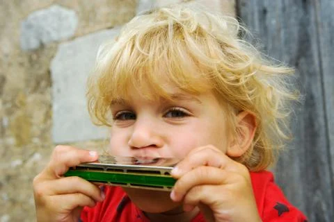 A boy playing the harmonica Stock Photos