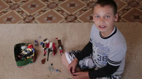 A boy playing home sitting on the carpet Stock Footage 64946591