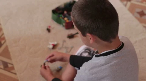 A boy playing home sitting on the carpet Stock Footage 64981867