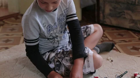 A boy playing home sitting on the carpet Stock Footage 65566852