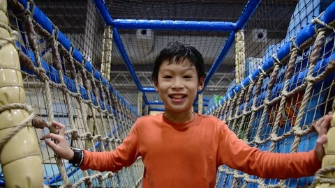 Boy playing in indoor playground Stock Footage 83149039