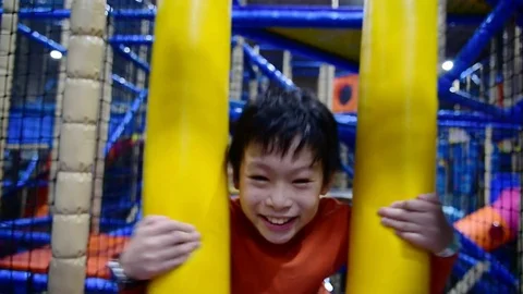 Boy playing in indoor playground Stock Footage 83149131