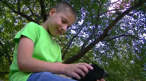 Boy playing on the iPhone Stock Footage 67859600