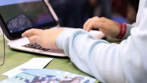 Boy playing with laptop in store Stock Footage 85358876