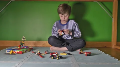 Boy playing with Lego on floor Stock Footage 46969823