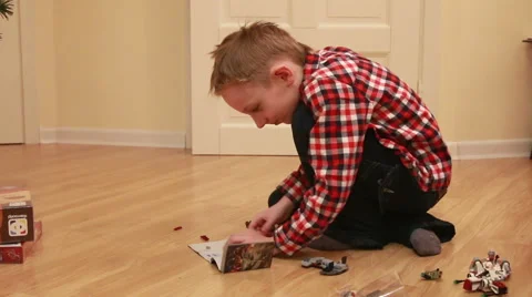 Boy playing with lego at home Stock Footage 48027146