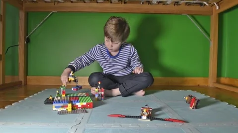 Boy playing with Lego in room Stock Footage 46969867