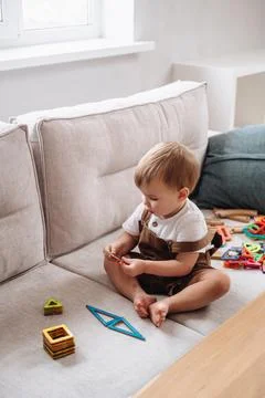 Boy playing with a magnetic construction set Stock Photos