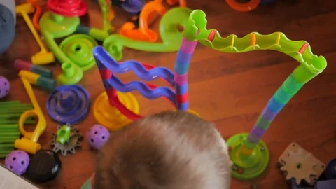 BOY PLAYING WITH MARBAL TOY.  Stock Footage 81898092