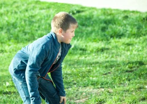 Boy playing in a meadow in the Park Stock Photos