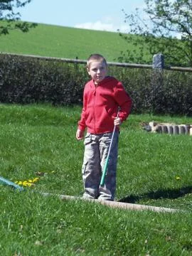 Boy playing minigolf Foto stock